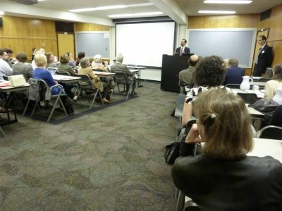 Local organizers Paul Hanebrink and Jim Niessen (at the podium) welcome the conference