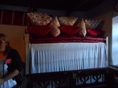 Bed with decorative pillows in the "tiszta szoba"